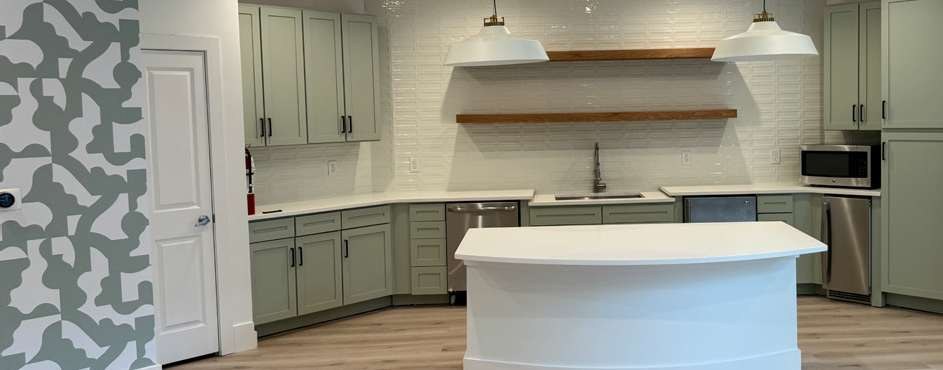 Remodeled kitchen with white island and pendant lighting