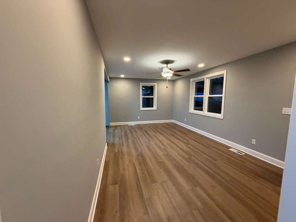 Completed kitchen with granite counters and blue cabinets