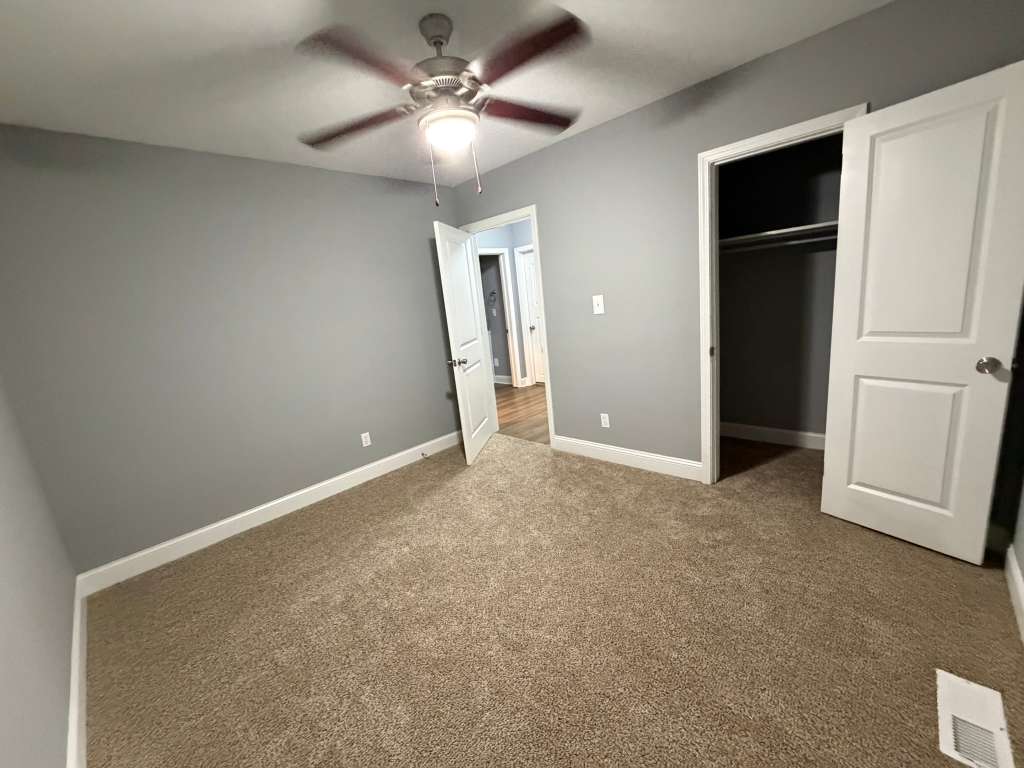 Finished living room with gray walls and new flooring
