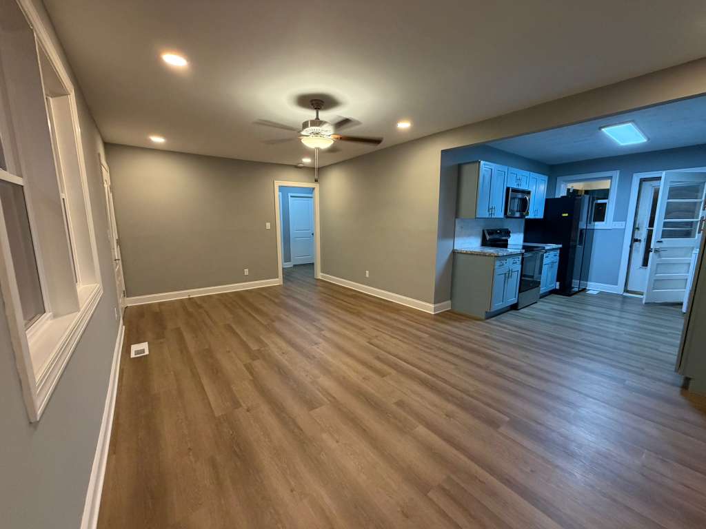 Completed open living and kitchen area with new flooring
